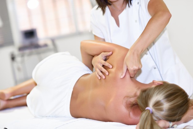 professional-female-physiotherapist-giving-shoulder-massage-blonde-woman.jpg