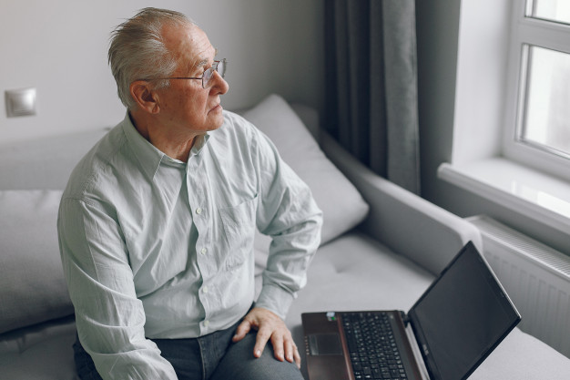 elegant-old-man-sitting-home-using-laptop.jpg
